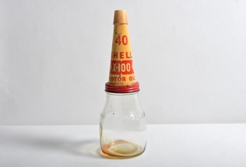 SHELL: A one imperial pint oil bottle, with 1950/60s "Shell X-100 Motor Oil" tin pourer and later plastic dust cover