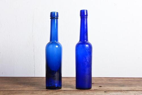 CASTOR OIL BOTTLES: Two cobalt blue ring seal castor oil bottles, 21cm high