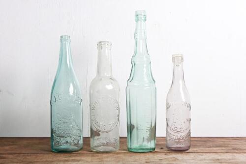 CONDIMENT BOTTLES: Four vintage embossed bottles, comprising two vinegar, one tomato sauce and one lemonade bottle