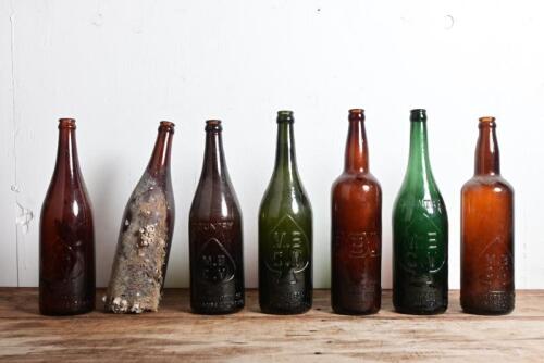 MELBOURNE BITTER: Six vintage embossed "MBCV" longneck beer bottles and an "ABA" bottle