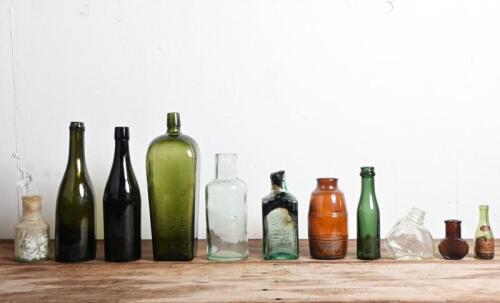 VINTAGE BOTTLES: A collection of vintage bottles, including beer, gin and "Bovril bottles