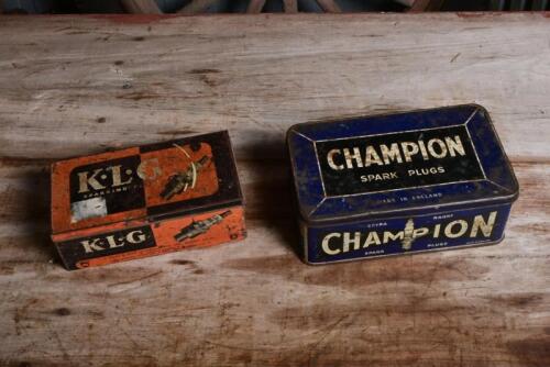 CHAMPION/KLG: Two circa 1960s metal spark plug tins, largest 19cm long