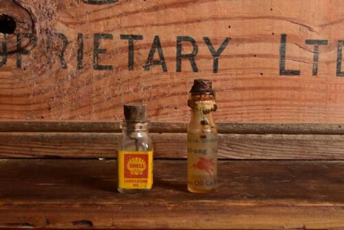 TRI-ANG/SHELL/MOBIL: Two small glass oil bottles for Tri-ang train set lubrications by Shell & Vacuum Oil Company