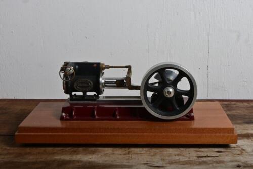 STATIONARY ENGINE: A small modern donkey engine by 'MCARCHANT WOODBROOK ENGINEERS', on wooden base, 12cm high, 34.5cm wide overall
