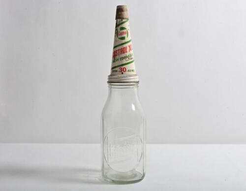 CASTROL: A circa 1960s "Castrol" embossed one quart oil bottle, with circa 1960s "Castrol XL New Formular 20-30-40 MS" tin pourer and dust cover