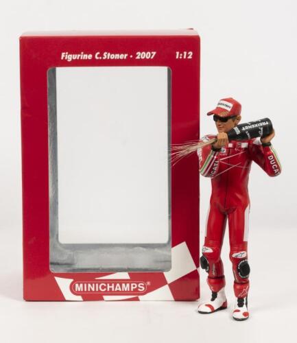 FIGURINE: A NOS 1:12 scale Minichamps Casey Stoner Championship Winner 2007 Podium Figurine