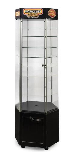 DISPLAY CABINET: A Matchbox Display Cabinet W60cm x H176cm x D45cm with Matchbox Collectibles/Dinky/Models of Yesteryear signage shaped as 6 acrylic sides with 1 side as an opening door with lock & key, movable on castor wheels with 8 shelves/lighting kit