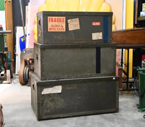 MILITARY BOXES: A set of three early 20th century military steel bound wooden nesting boxes with lids, the smallest with "On His Majesty's Service" label, the largest 39xm high, 88cm wide, 47cm deep