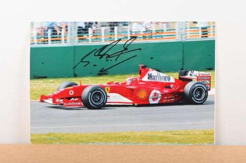SCHUMACHER: A colour picture of Michael Schumacher racing a Ferrari F2004 at the 2004 Australian Grand Prix, Melbourne. Michael Schumacher signature