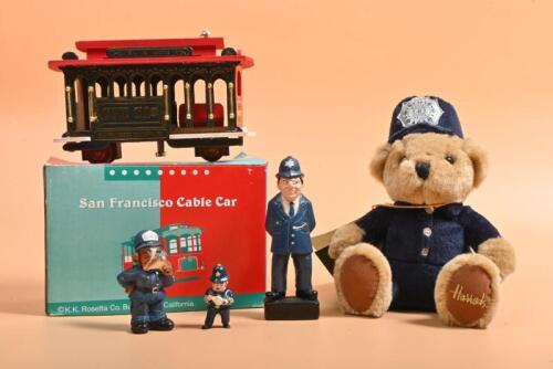 ENGLISH POLICE: A collection of various items associated with English Police including a Harrods Soft Toys Teddy Bear, a P.C figurine, a resin POLICE dog. Cable Car