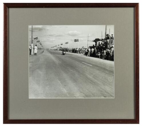DICKIE DALE: A framed and glazed photographic print of Ted Lawton's image of Moto Guzzi rider Dickie Dale winning the Victorian Grand Prix at Mildura December 26, 1955.
