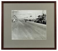 DICKIE DALE: A framed and glazed photographic print of Ted Lawton's image of Moto Guzzi rider Dickie Dale winning the Victorian Grand Prix at Mildura December 26, 1955.