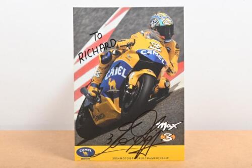 MAX BIAGGI: A colour publicity card of Max Biaggi from the 2004 Moto GP World Championship. Personally inscribed and signed by Max Biaggi