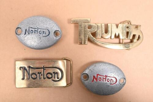 NORTON/TRIUMPH: Two belt buckles and a pair of Norton engine caps, the largest buckle 12.5 x 5cm