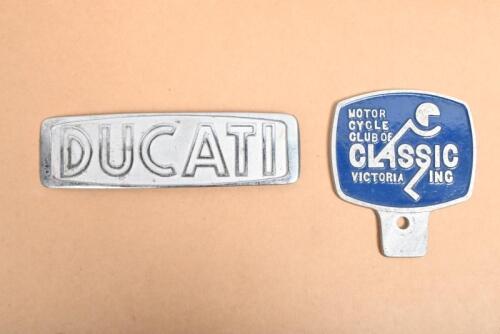 CMCCV/DUCATI: A Classic Motor Cycle Club of Victoria membership badge and a cast alloy Ducati emblem, lacking one pin at the back, the membership badge 11 x 10cm