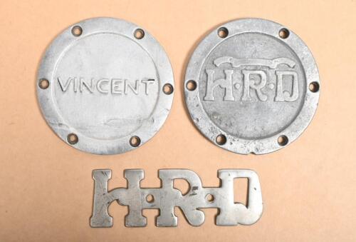 VINCENT/HRD: Two aluminium engine discs for Vincent and HRD and an HRD engine badge, discs 10.5cm diameter each
