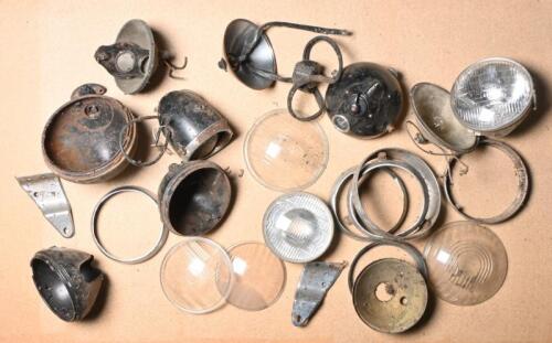 HEADLAMPS: A collection of assorted mainly British headlamps and glass lenses to suit cars and motorcycles, including Lucas and a Huret with speedometer and others