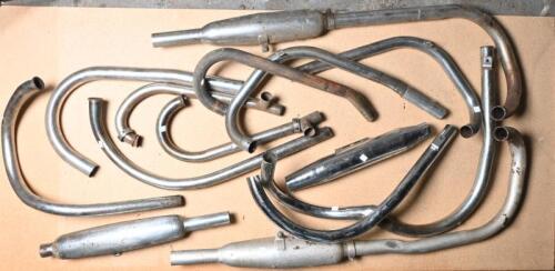 EXHAUSTS: A collection of miscellaneous exhaust pipes including four mufflers