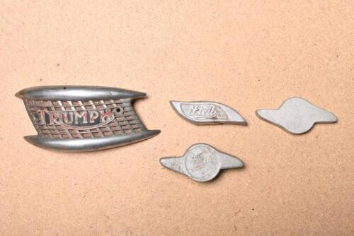 TRIUMPH: A circa 1960s Triumph tank badge together with three re-cast aluminium paperweights with 'Ford' & 'Steil'